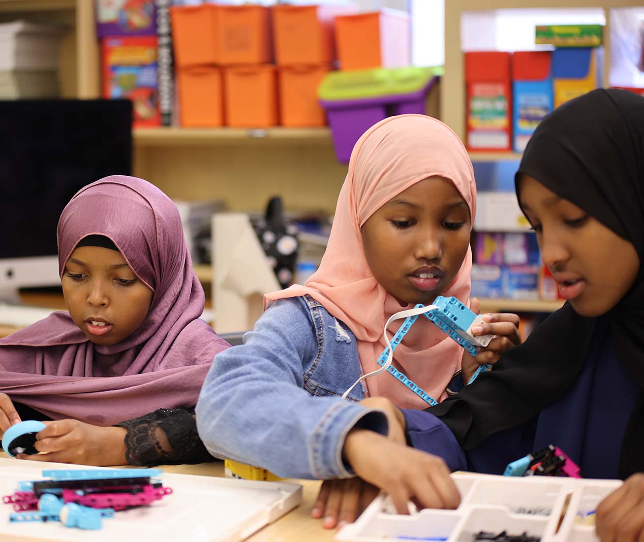 Student working on a notebook in a classroom.